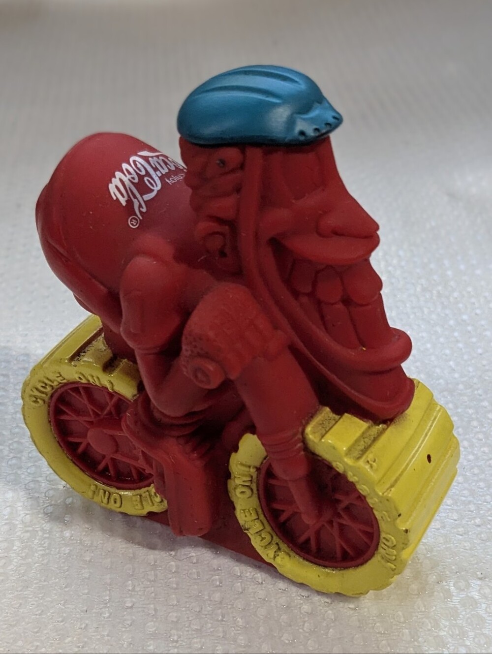 Coca Cola Red Rider Figure with Yellow Wheels and Blue Helmet